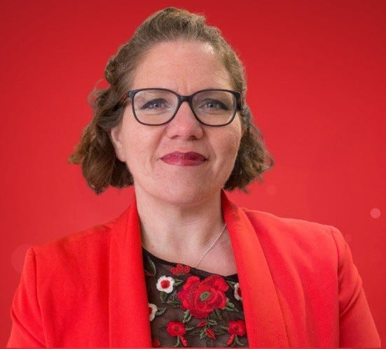 A women with glasses wearing a red outfit