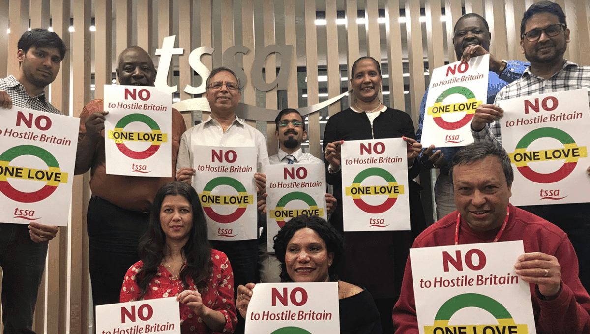 Photo of people holding up 'No to hostile Britain' posters from TSSA BAME Emix group at TSSA HQ