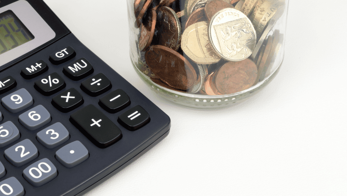 Photo showing calculator and jar of coins