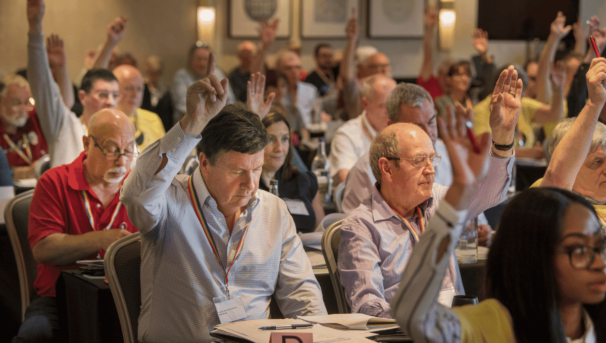 TSSA conference delegates voting with hands in the air