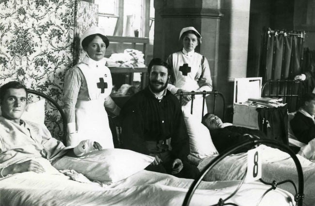 Soldiers in hospital being looked after by two nurses