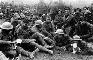 British prisoners of war sitting together on the ground during the First World War.