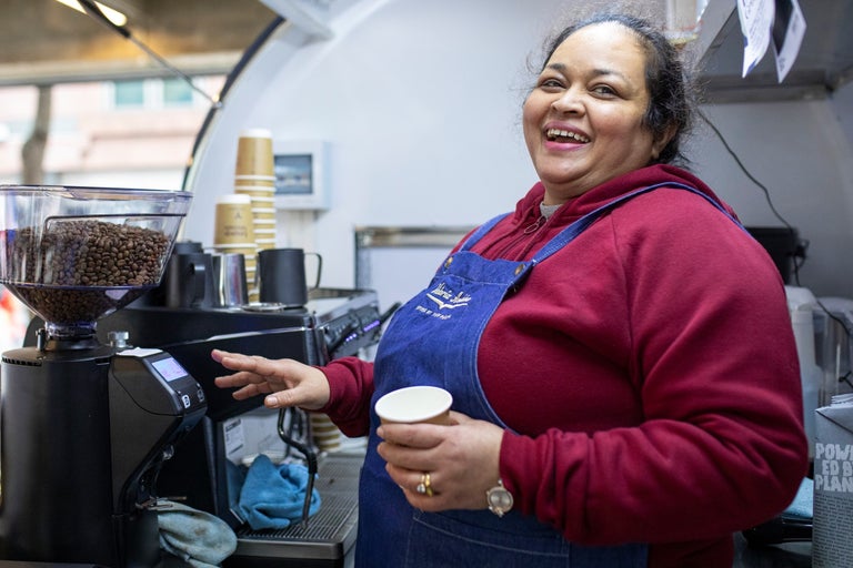 A barista making a coffee