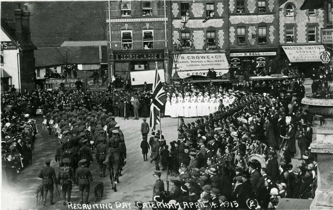 A black and white image showing groups of Red Cross volunteers gathered among huge crowds on recruiting day in Caterham on 14 April 1915.