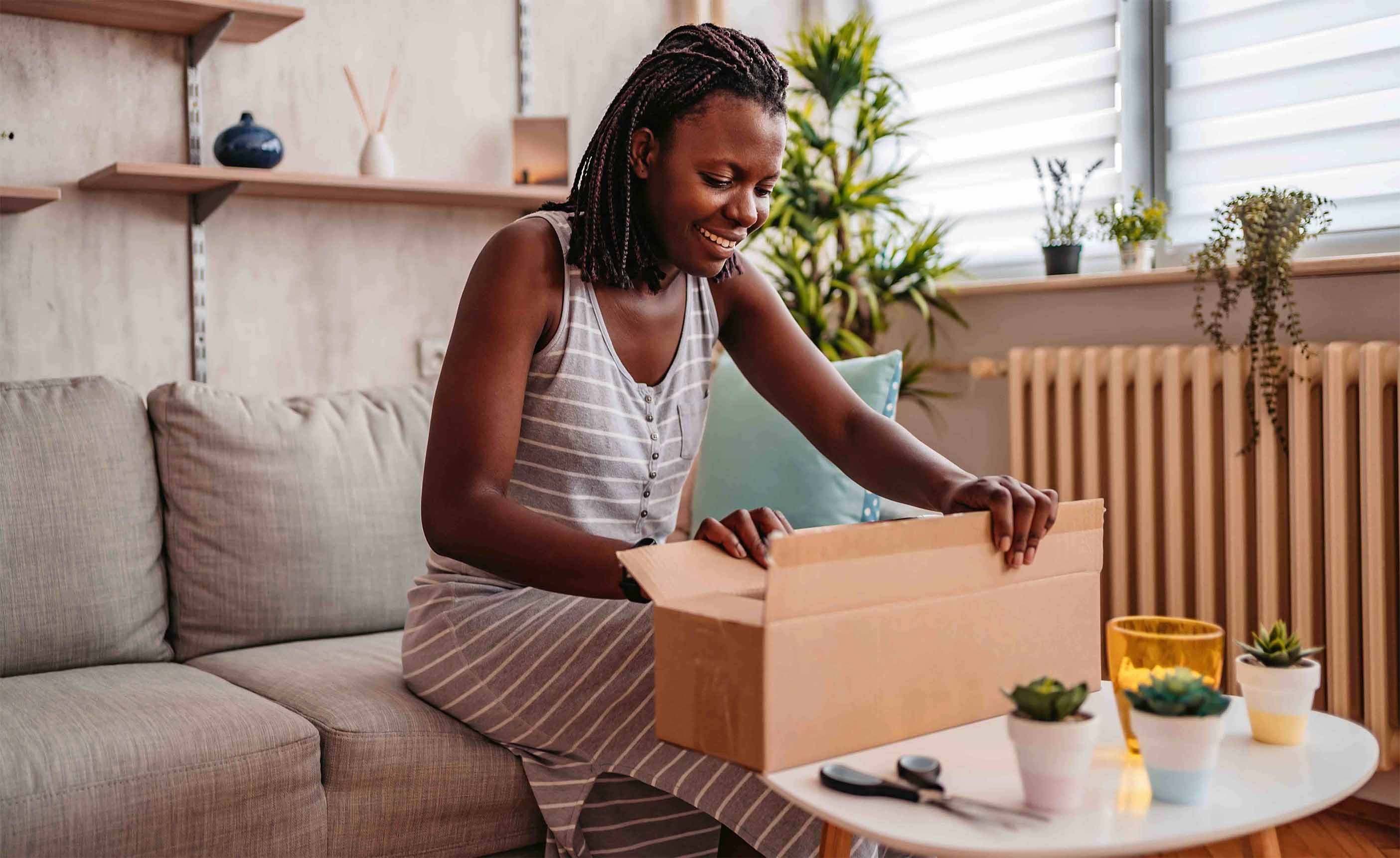 Picture of a woman unpacking a box.