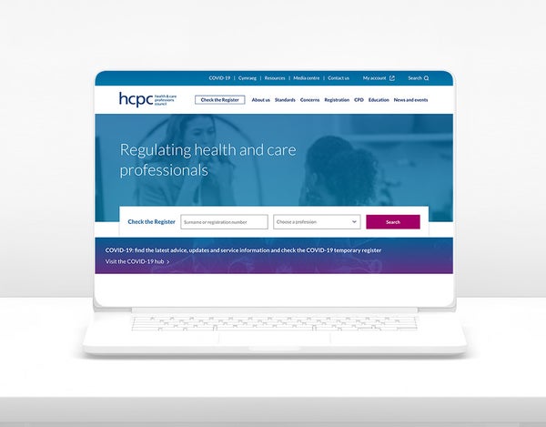 An open laptop showing HCPC's homepage.
