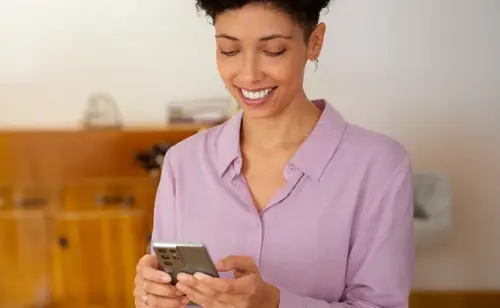Image of a woman holding a mobile phone.