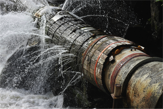 A leaky pipe spurting out water on all sides as a symbol of technical debt accumulating in developers code.