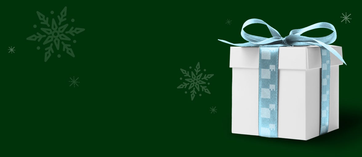 A white present with a blue bow and green festive background