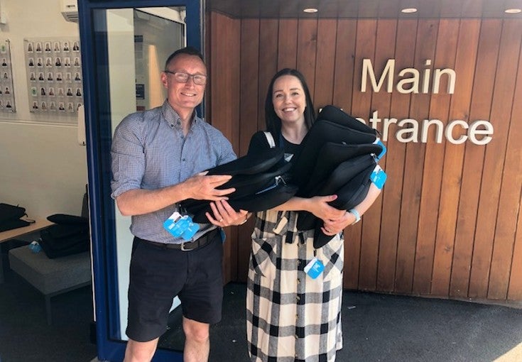 Man and woman holding chromebooks