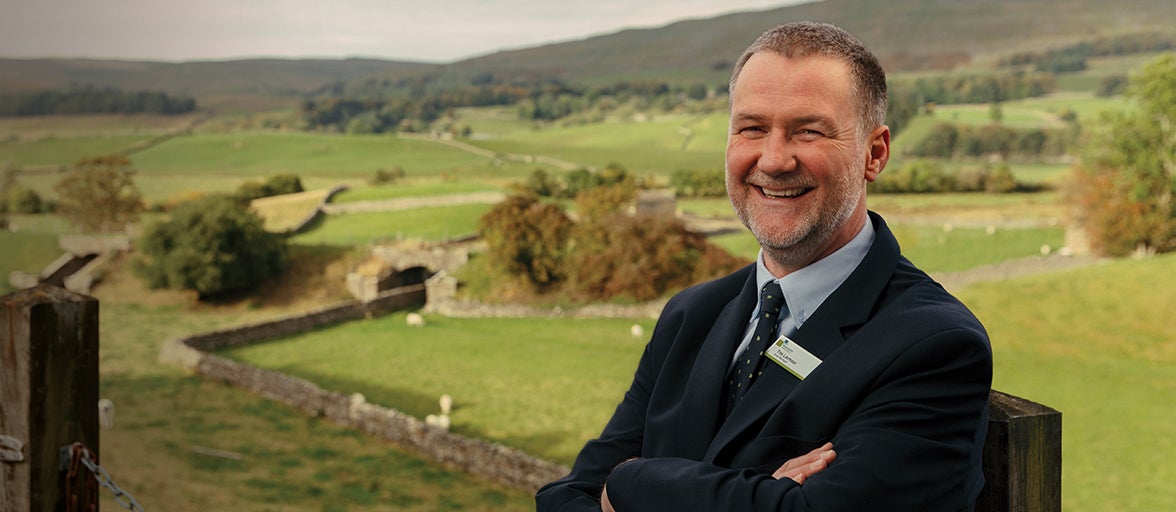 Our Hawes Branch Manager sat on a bench is the countryside