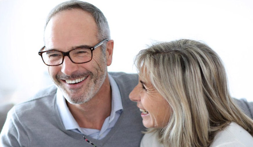 Man and woman sat together laughing 