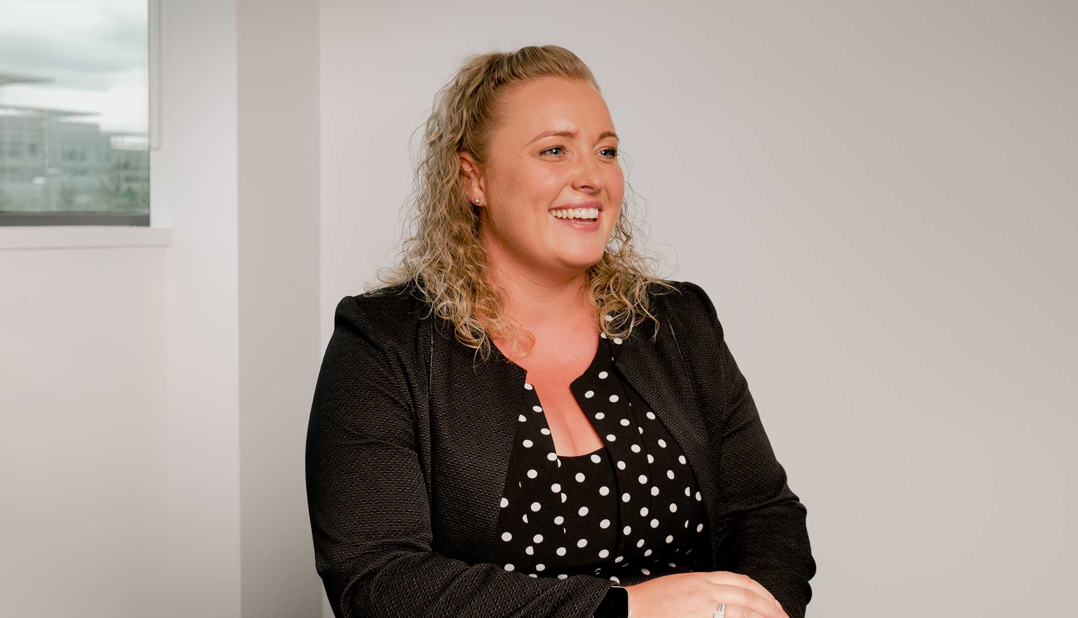 Newcastle Financial Adviser, Olivia Vickers, sat in their head office, smiling. 