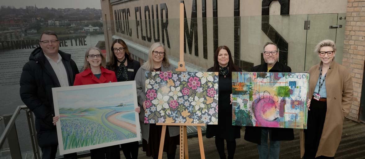 A group photo of artists, Newcastle Building Society and the Baltic art gallery staff. The three artists holding up their artwork.