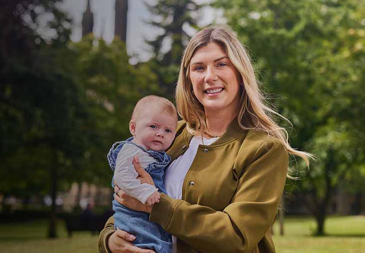 A woman holding a baby