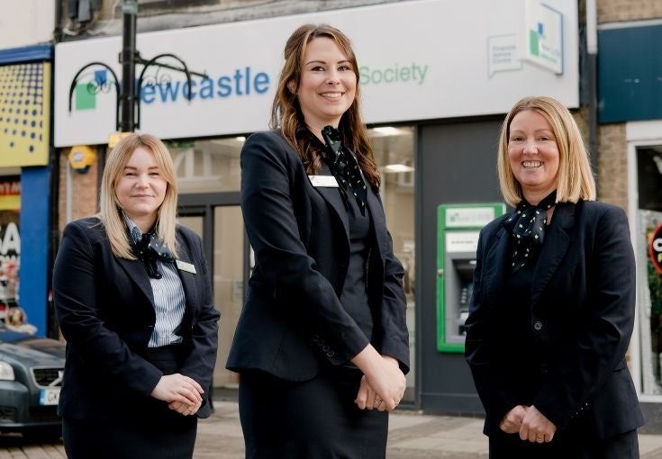 Three NBS staff stand outside a branch in Bishop Auckland