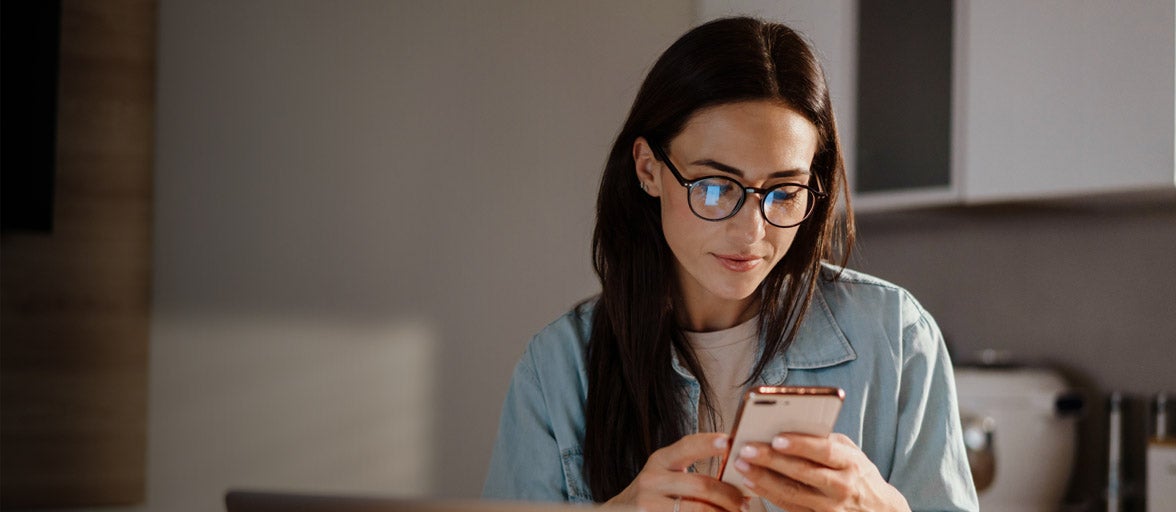 A woman looking at a mobile phone.