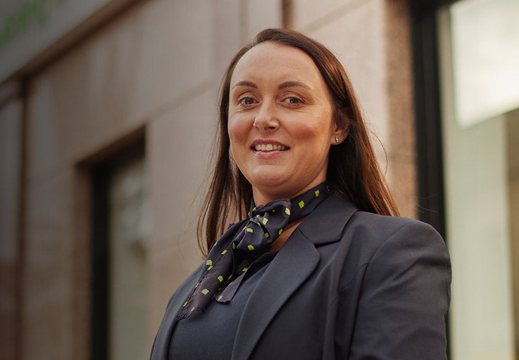 Branch Manager, Donna, stood in front of Sunderland's branch. She's smiling, looking straight towards the camera. 