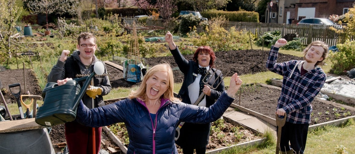 Four people celebrating on an allotment
