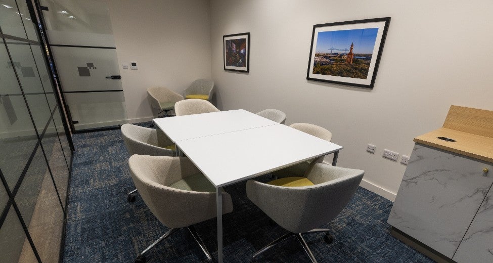 A community room with a table and chairs at Newcastle Building Society's Middlesbrough branch.