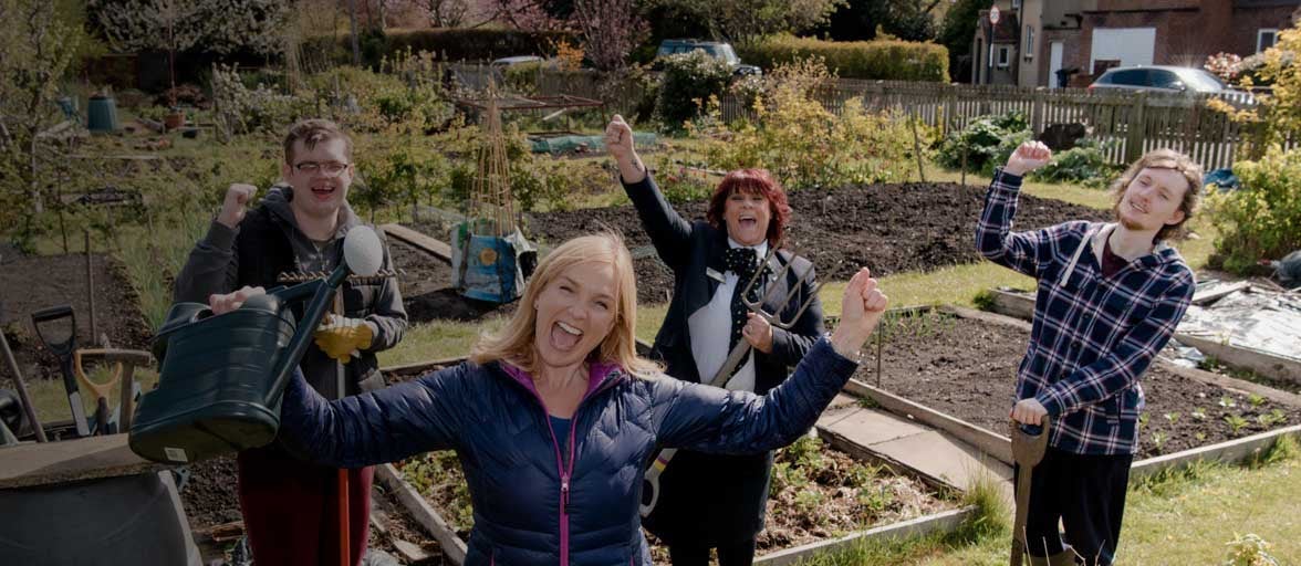 Four people celebrating in an allotment.