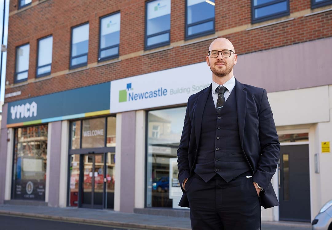 North Shields Branch Manager, Conor, stood outside of the branch smiling. 