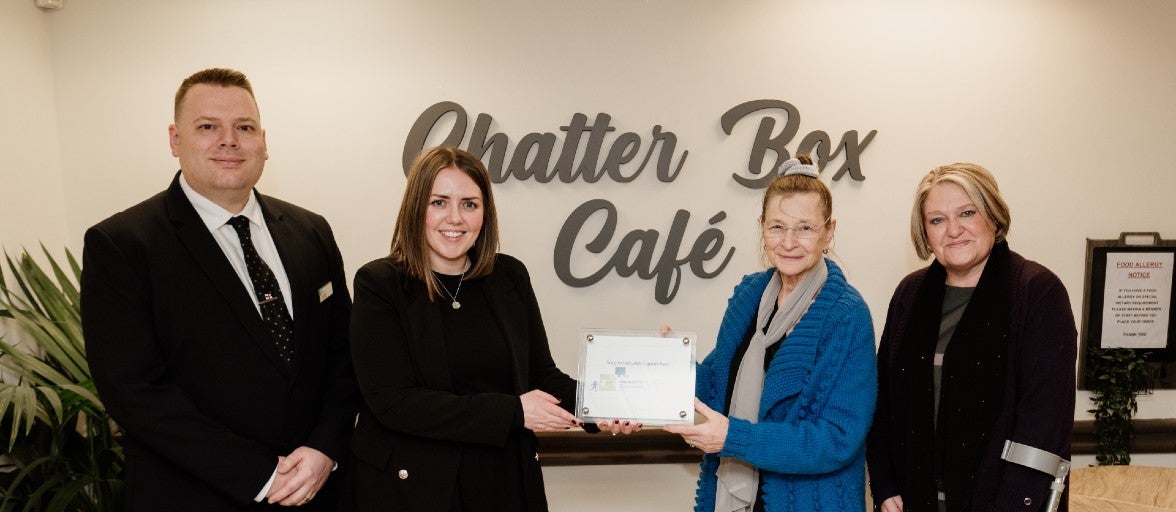 Morpeth Branch Manager, Lee Willis, and our Head of Conduct Risk, Suzanne Wood, stood in Vision Northumberland's Chatter Box café, with their Chair, Mala James, and Chief Officer, Julie Boyack.