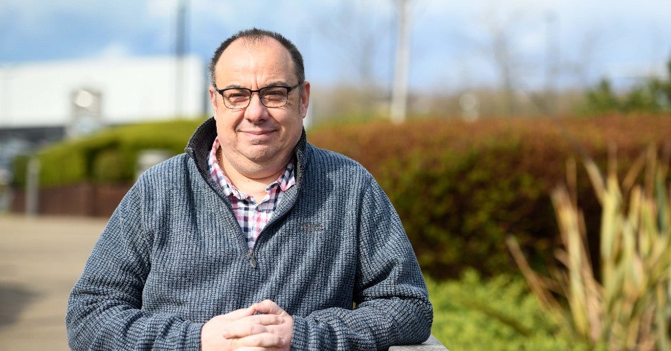 Darren, a Customer Advisor, stood outside our Cobalt office, smiling at the camera. He joined us through our partnership with Walking With The Wounded.