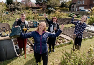 Four people celebrate in an allotment