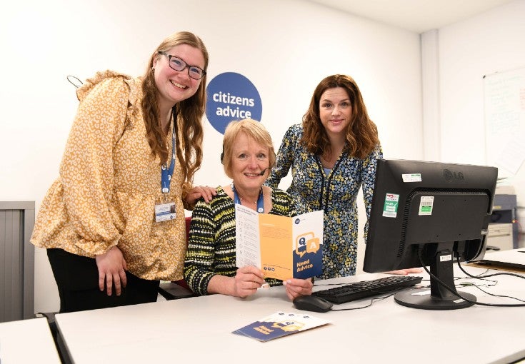 Three ladies sat down behind a computer at Citizens Advice