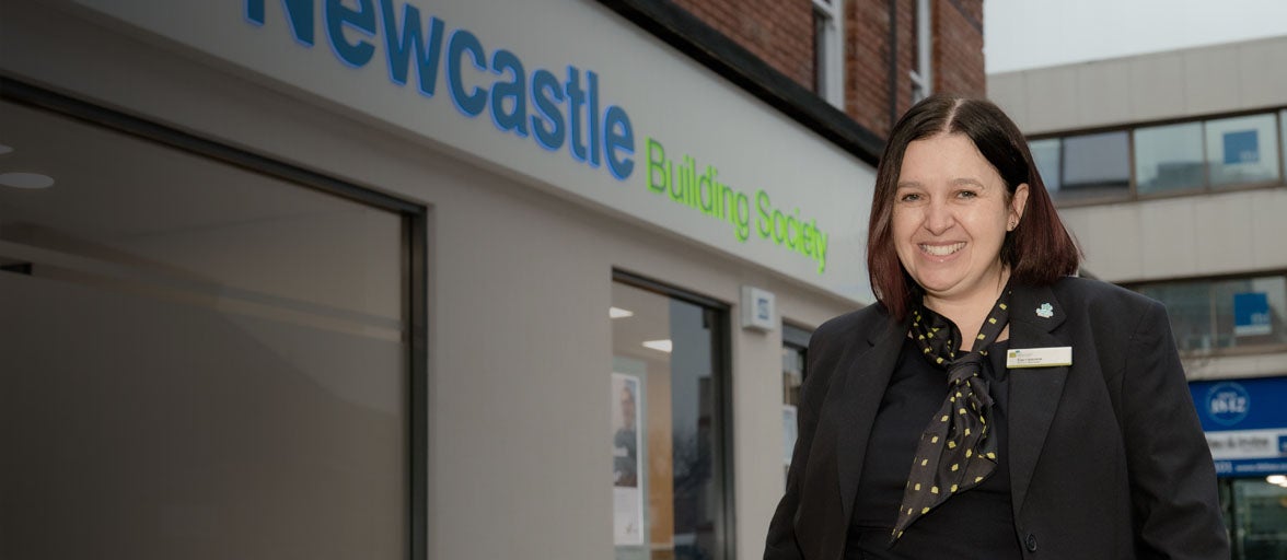 Exterior photo of the newly refurbished Hartlepool branch, with Carrieanne, the Branch Manager, stood outside smiling. 