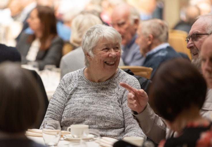 A lady smiling at another member of her table at our Member Event at Wynyard Hall.