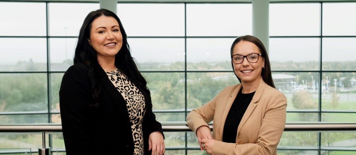 Two of our colleagues from Newcastle Financial Advisers inside our Head Office at Cobalt Business Park. On the left is Beth Hunter, Paraplanning Team Leader, and on the right is Beth Muir, Operations Team Leader.