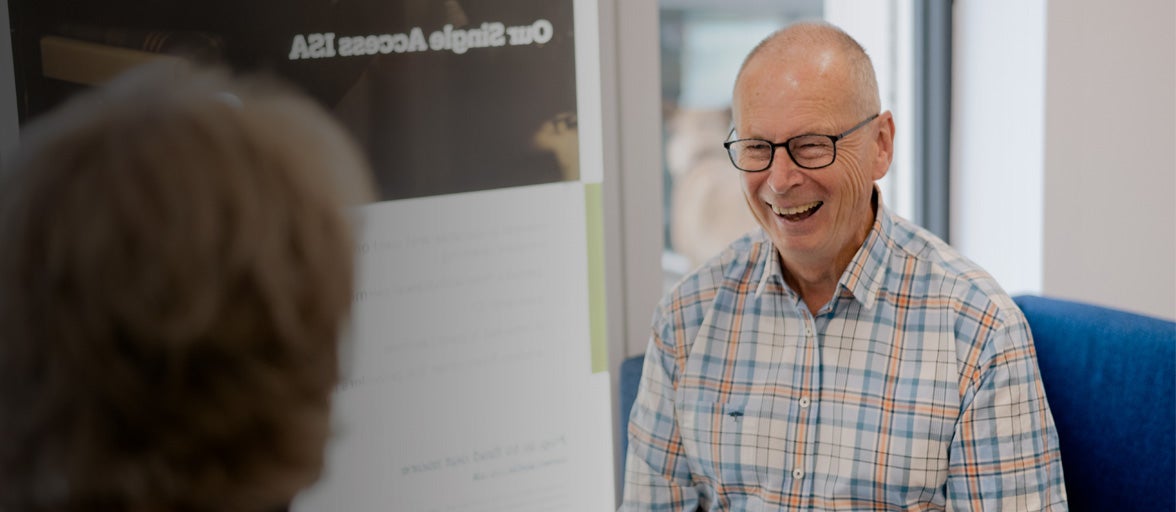 A man laughing at another man in a branch