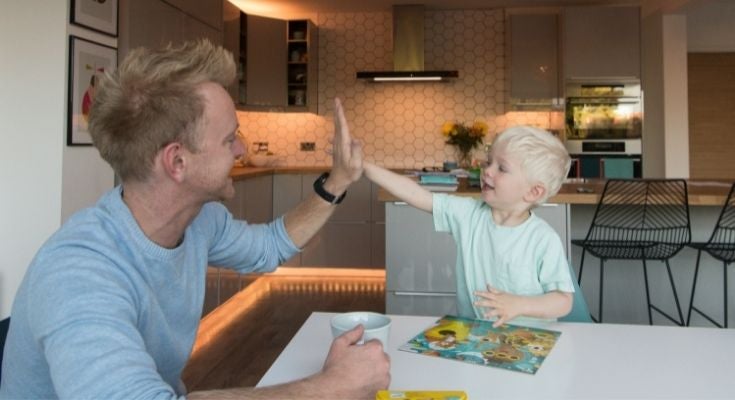 Dad giving his son a high five