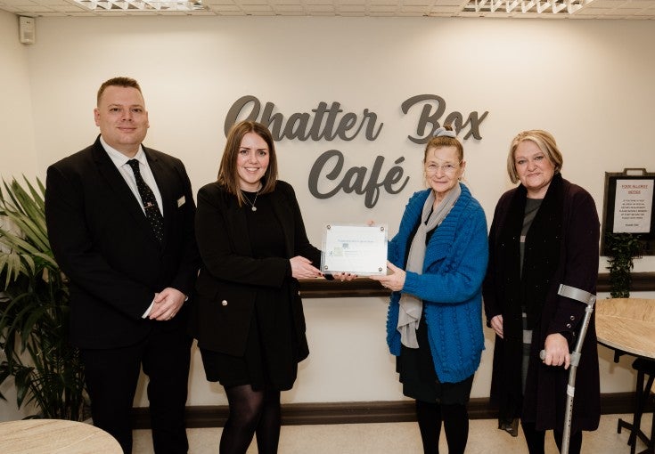 Morpeth Branch Manager, Lee Willis, and our Head of Conduct Risk, Suzanne Wood, stood in Vision Northumberland's Chatter Box café, with their Chair, Mala James, and Chief Officer, Julie Boyack.