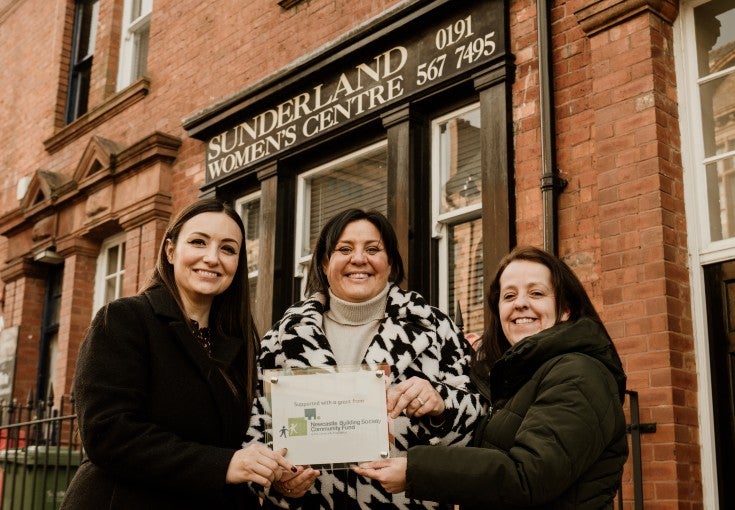 Jennie Pitt, Head of Diversity, Equality and Inclusion at Newcastle Building Society Group stood with Andrea Bulmer and Jayne Simpson of Sunderland Women's Centre, holding a commemorative plaque. 