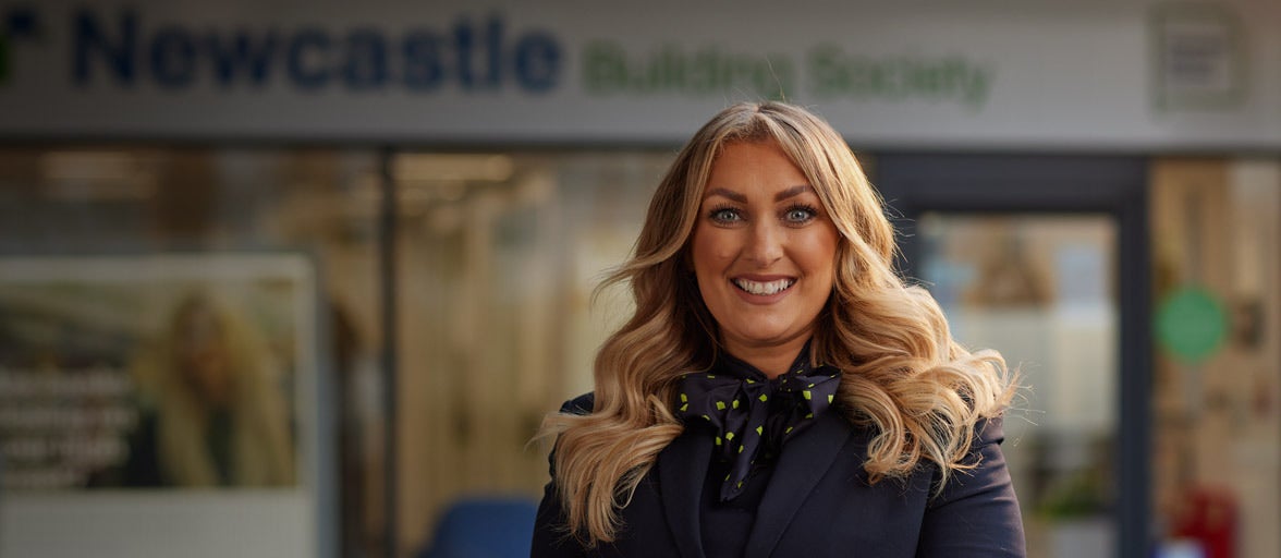 Ponteland's Branch Manager, Natalie. Stood in front of the branch smiling. 