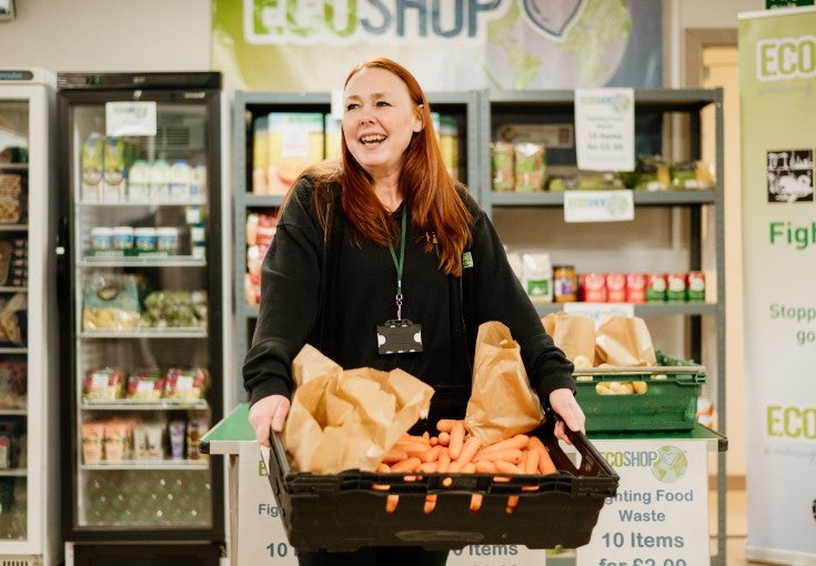 Lisa Harris, Eco-Shop Coordinator at Middlesbrough Environment City, holding a crate of carrots.