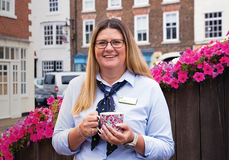 Branch colleague on Stokesley high street holding a coffee