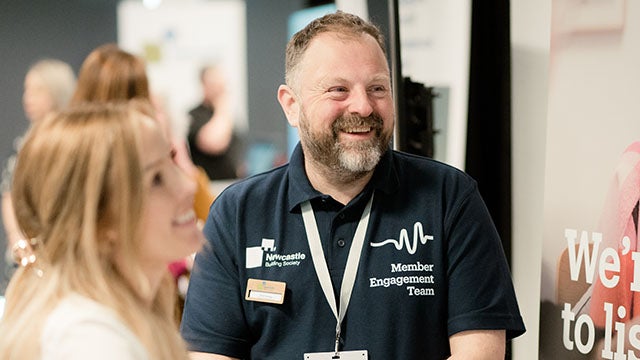 A man smiling at a woman