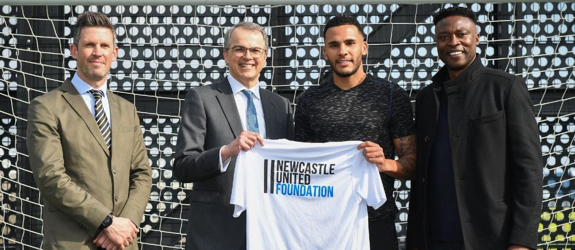 Andrew Haigh and Newcastle United club captain Jamaal Lascelles hold a T-shirt at the new NUCASTLE building.