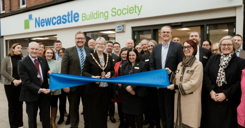 A group of people stood outside of the Newcastle Building Society Hartlepool branch, preparing for a ribbon cutting.