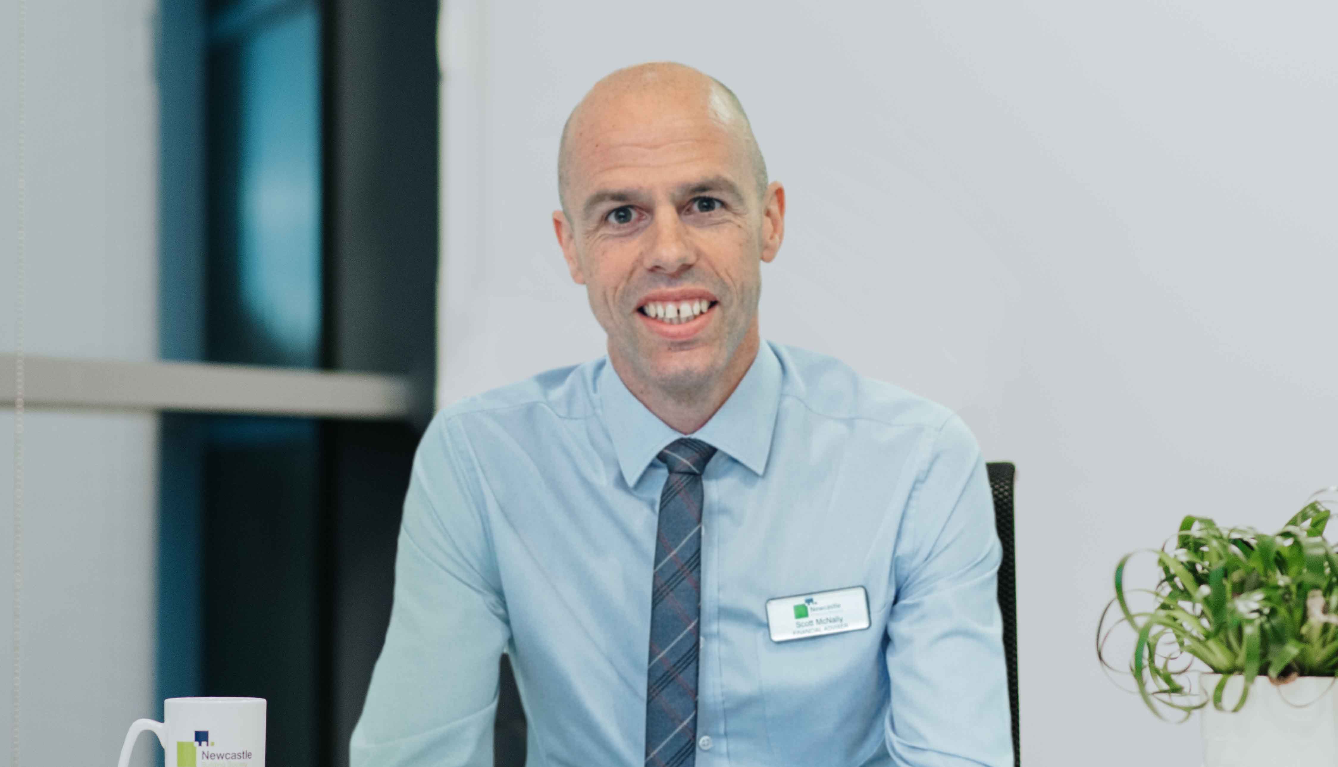 Man smiling at an office desk