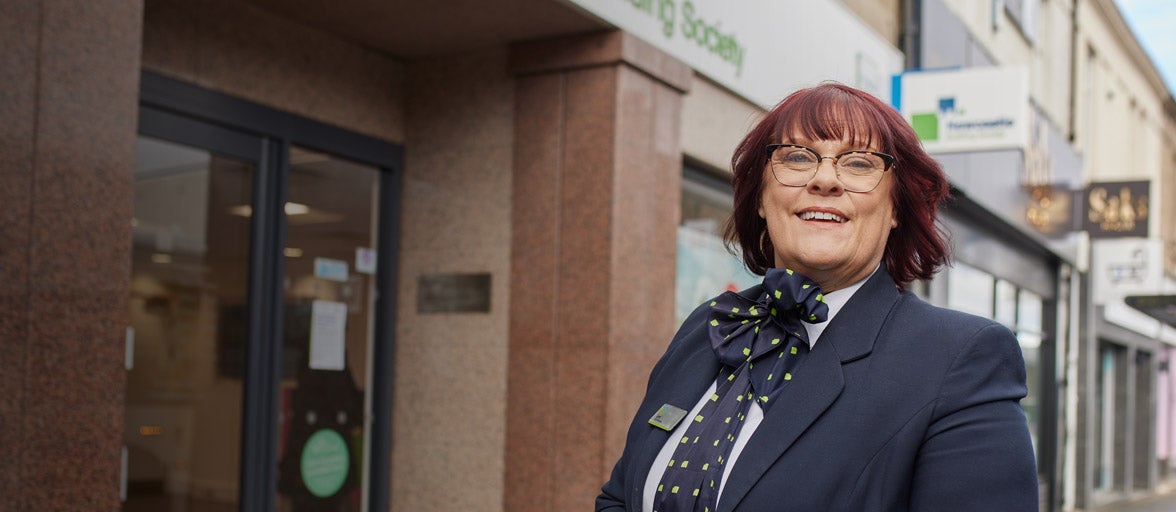 Branch Manager, Lynn Richardson stood outside of the Gosforth branch smiling. 