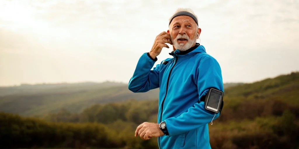 Man out running with mobile phone strapped to his arm
