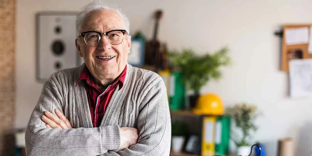 Portrait of a smiling elderly man with glasses