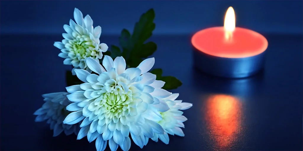 Memorial flowers with small light candle