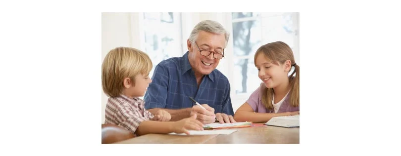 Grandfather drawing pictures with his grandkids