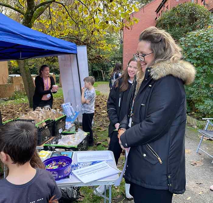 People smiling and looking cheerful at a stall